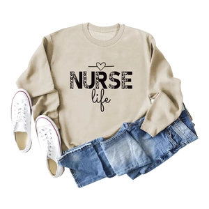Detail of beige sweatshirt featuring NURSE Life leopard print text and soft cotton texture