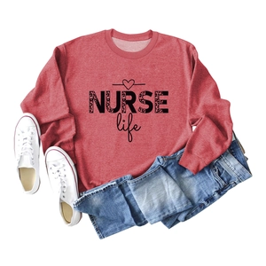 Flat lay of red long sleeve sweatshirt with leopard nurse life print and blue jeans
