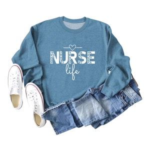 Flat lay of blue crewneck sweatshirt with NURSE Life heart print and denim jeans