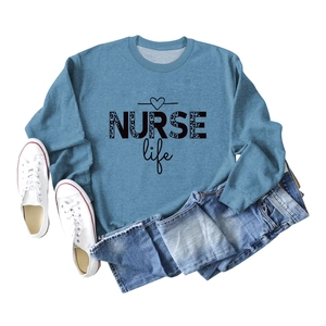 Flat lay of blue crewneck sweatshirt featuring NURSE life leopard print and heart detail