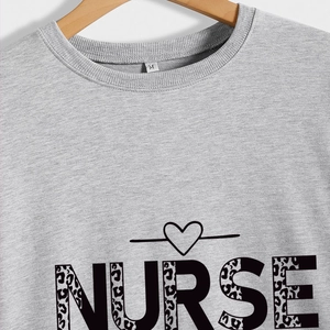 Grey pullover sweatshirt with leopard print NURSE text and heart detail on wooden hanger