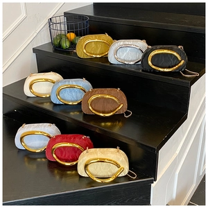 Close-up of vibrant evening bags with pleated texture and stylish large C-shaped handles