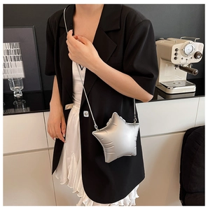 Silver star-shaped crossbody bag with metallic sheen and elegant metal chain detail