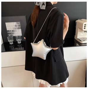 Chic silver star-shaped crossbody bag with a sleek metallic finish and thin snake chain strap