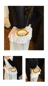 Detail of cream white half-moon crossbody bag with gold C-shaped metal ring and chain