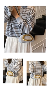 Detail of light blue cloud bag with golden ring handle and elegant metal chain strap