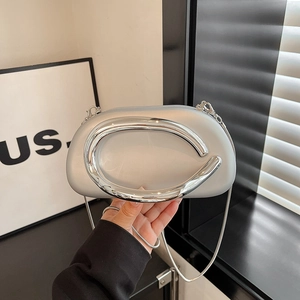 Silver metallic mini clutch bag with circular handle and chain strap for evening parties