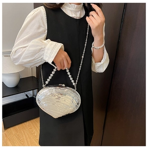 Silver shell-shaped acrylic clutch bag with beaded handle and metallic ripple texture