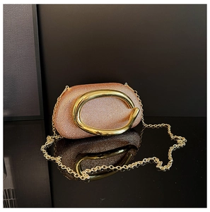 Detailed view of rose gold evening clutch bag with sparkling crystals and metal handle