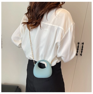 Light blue mini handbag with gold chain strap shown on model for size and style