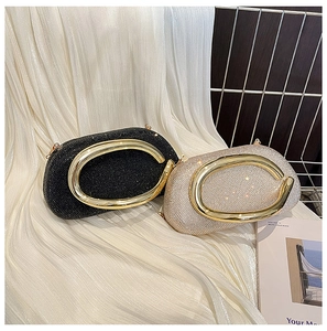 Detail of luxury evening clutch bags with rhinestone finish and gold metal handles