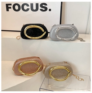 Four glitter evening clutch bags in black silver and gold colors with oval metal handles