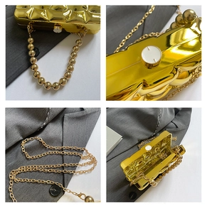 Detailed close-up of golden metallic quilted clutch with bead handle and chain strap