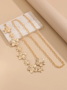 Close-up of golden star-shaped charm waist chain with textured metallic petals