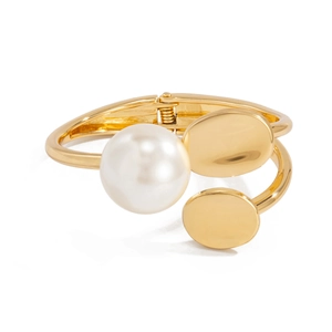 Elegant gold-tone geometric bangle featuring a large white pearl and polished metal accents