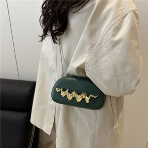 Dark green oval box bag with gold wavy hardware and metal chain strap for women