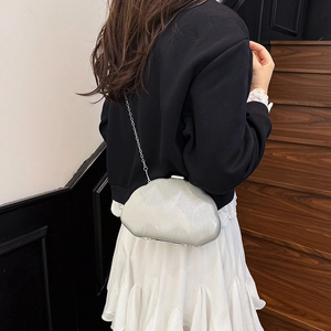 Elegant silver shell-shaped evening clutch bag with glitter finish and metal chain strap