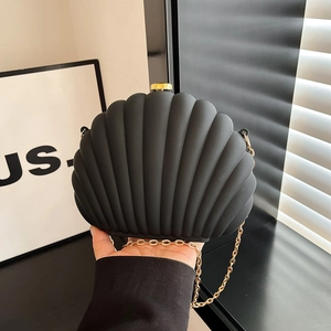 Elegant black shell-shaped evening clutch bag with gold chain strap and metal clasp