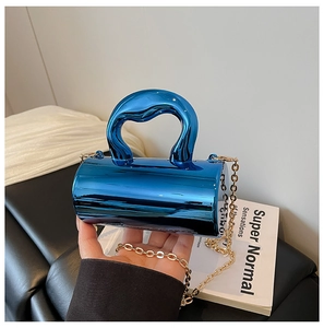 Detail of blue metallic cylindrical handbag with artistic handle and gold chain strap