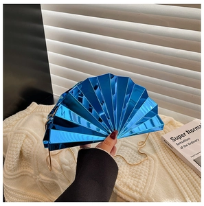 Detailed view of deep blue fan-shaped acrylic evening bag with gold chain strap