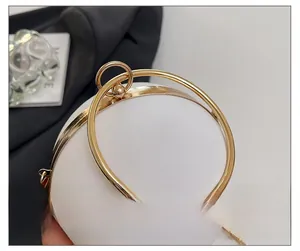 Detail of elegant white spherical evening bag with golden circular metal handles