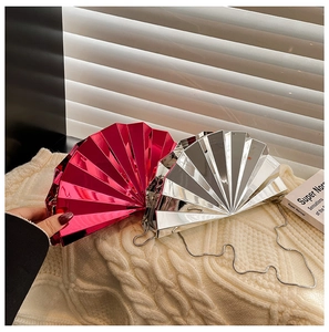 Detail of fan-shaped evening clutch with pleated design and metallic chain strap