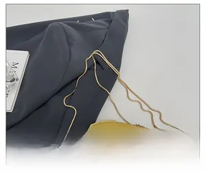 Detail shot of the luxury gold snake chain strap on an acrylic evening clutch bag