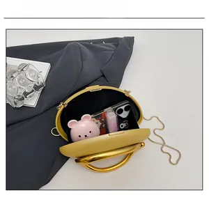Interior capacity of yellow acrylic clutch showing space for phone and lipstick