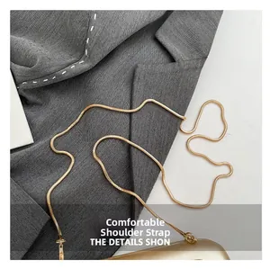 Detail of elegant gold snake bone chain strap with metal clasps for evening clutch bags