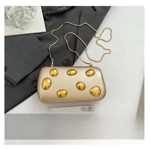 Champagne gold evening clutch bag with metallic details and snake chain shown with phone