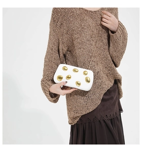 White hard shell clutch bag with gold metallic art decor and elegant metal chain strap