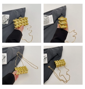 Detail shots of the golden bubble textured evening clutch bag with chic metal chain strap