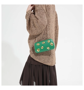 Metallic green evening clutch bag with gold oval accents and silver chain strap for women