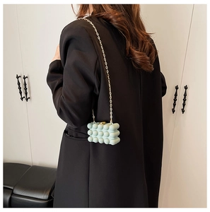 Close-up of light blue bubble texture mini acrylic box bag with golden chain strap