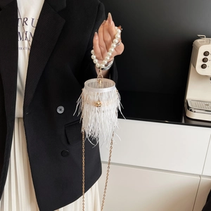 Elegant white ostrich feather bucket bag with pearl handle and gold chain strap