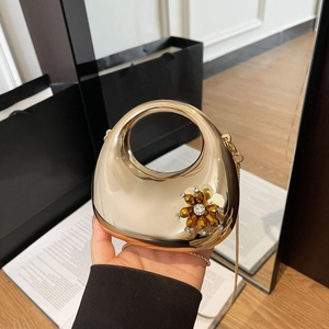 Golden egg-shaped evening clutch bag with sparkling rhinestone flower and chain strap