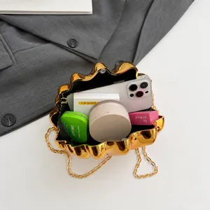 Top view of gold shell clutch bag interior showing space for phone and makeup