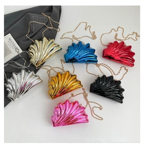Collection of shell-shaped metallic evening bags with elegant chain straps in various colors