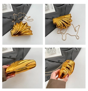 Macro detail of golden seashell clutch bag showing mirror metallic texture and chain