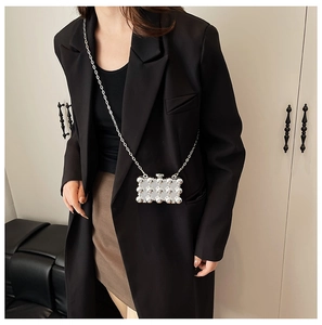 Mini silver flask-shaped acrylic purse with metallic beads and a delicate chain strap