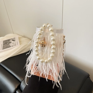 Close-up of luxury white ostrich feather handbag featuring elegant large pearl handles