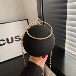Elegant black spherical evening clutch bag with gold round handle and chain strap
