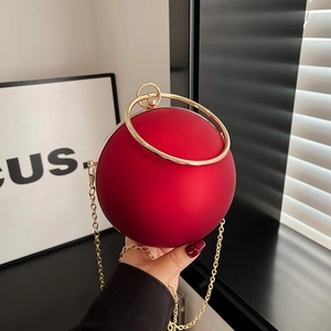 Chic red sphere evening bag with gold ring handle and chain strap for women