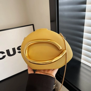 Yellow leather clutch bag with oversized gold metal buckle and snake chain strap