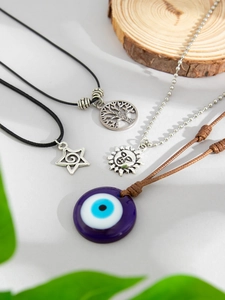 Detail of multi-layer evil eye and tree of life pendants with beaded chains and cords