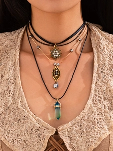 Detailed view of bohemian layered necklace set with blue crystal and star pendants