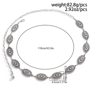 Detail of vintage silver alloy waist chain showing oval textured links and lobster clasp