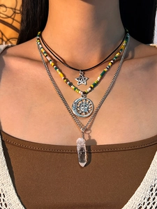 Detail of bohemian layered necklace set featuring crystal pendant and colorful beads