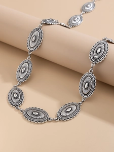 Detail of silver bohemian chain belt with vintage oval links and sunburst texture