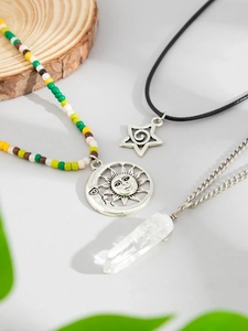 Detail of bohemian layered necklaces with colorful beads, sun moon and crystal pendants
